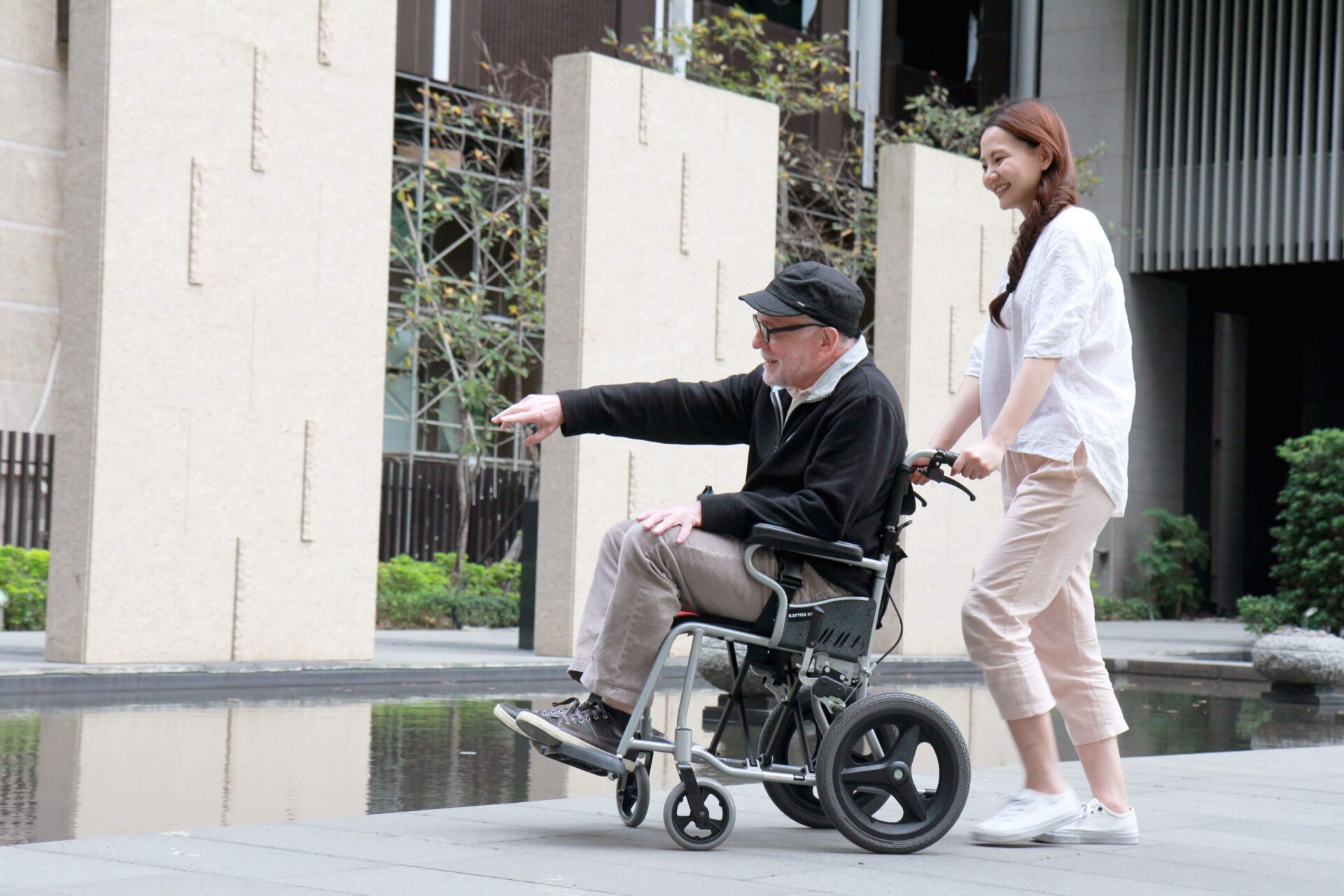  An-elder-in-a-standard-wheelchair-with-a-young-female-caregiver