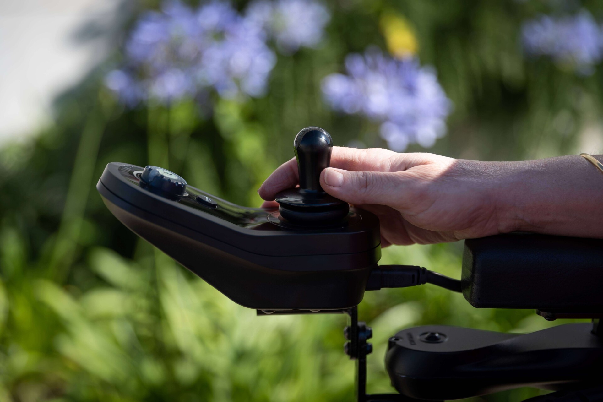 A-person-controlling-the-joystick-of-a-power-wheelchair 